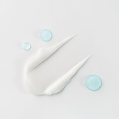 Smear and drops of cosmetics on a white background