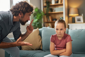 A father is expressing concern while talking to his daughter, who appears upset and disinterested....