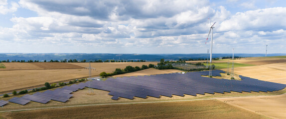 Solar panel station, wind turbine park, agriculture field with windmills, renewable sustainable energy, electricity technology, environment conversation