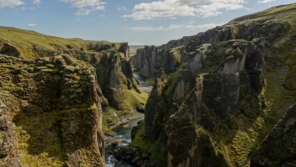 Fototapeta premium Fjadrargljufur Canyon and the shallow creek which flows along the bottom of the canyon, Southern Iceland