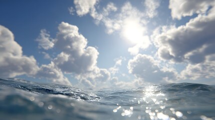 Fototapeta premium View of ocean water surface with sun shining through clouds in a bright blue sky landscape scene