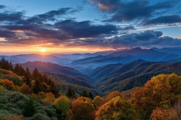 Golden sunrise illuminates misty mountain peaks during autumn foliage season