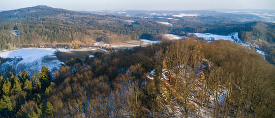 The ruins of Bradlec Castle and the snowy Czech landscape
