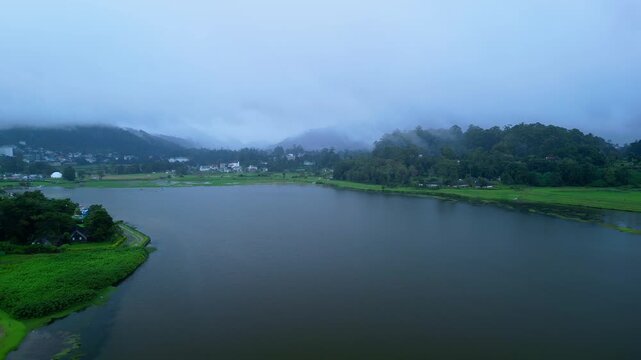 Drone Footage Of Foggy Lake Gregory Surrounded By Lush Green Countryside