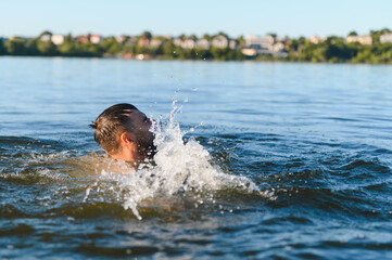 Man drowning in a lake is gasping for air