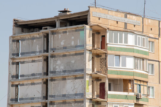 Damaged residential building after missile strike, destroyed part of building, reinforced structure, consequences, terror, in Krivoy Rog