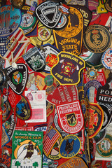 Colorful collection of police and fire department patches from around the world displayed together as a tribute to first responders and their service