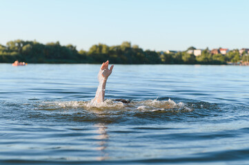 Man drowning in river is raising hand asking for help