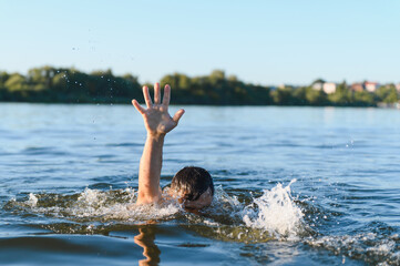 Man drowning in river is raising hand asking for help