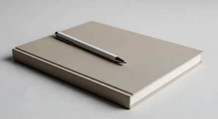 Closed Book with Pen Resting on Top in Neutral Setting