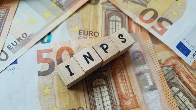 INPS acronym made of wooden letter cubes on pile of Euro banknotes. Istituto Nazionale della Previdenza Sociale (National Institute of Social Security)