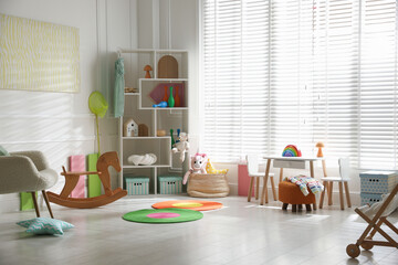 Stylish playroom with toys and furniture. Interior design