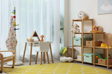Stylish playroom with toys and furniture. Interior design