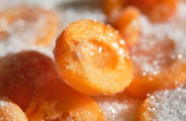 Cooking apricot jam with sugar. Shallow depth of field