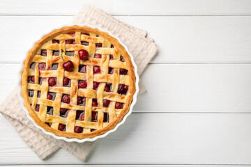 Tasty cherry pie on white wooden table, top view. Space for text