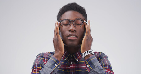 Headache, glasses and black man in studio with eye strain for migraine, brain fog and pressure....