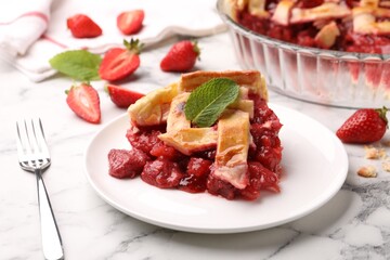 Piece of tasty strawberry pie and berries on white marble table, closeup