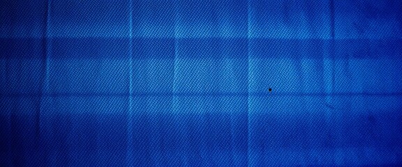 Faded indigo denim texture with visible wear and tear, uneven coloring, worn, fabric