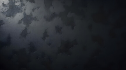 Close up of a dark textured surface with subtle variations in tone and light creating an abstract moody and sophisticated background