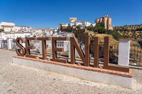 Panoramic view of the beautiful white village of Setenil de las Bodegas since lookout in Cadiz, Spain, with the church and castle in a sunny day.