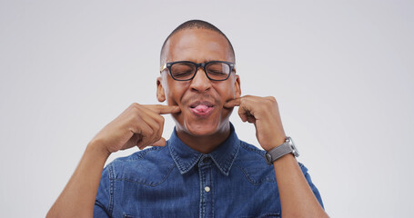 Funny face, glasses and tongue out with black man in studio for comic, meme or joke. Facial...