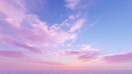 Fototapeta premium Serene Sunrise Over Tranquil Ocean Water with Soft Pink and Blue Pastel Clouds in the Sky at Dusk