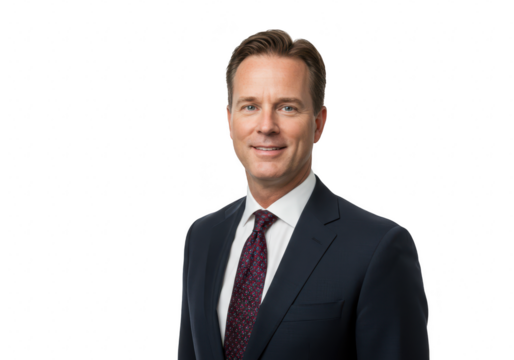 A confident caucasian businessman in a dark suit and tie smiles while looking at the camera, isolated on a transparent background