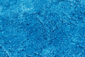 Close-up of a textured blue surface, resembling water or paint
