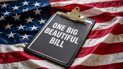 A clipboard with the words one big beautiful bill rests on the stars and stripes of the american flag