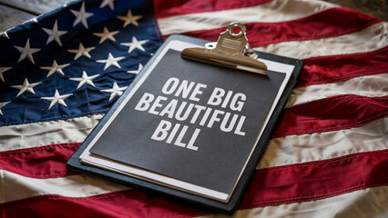 A clipboard with the words one big beautiful bill rests on the american flag symbolizing legislation and national policy