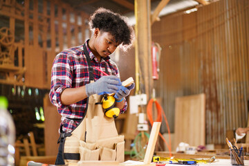 Professional African male carpenter is working professionally in sawmill - workshop.