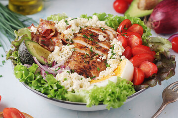 A bowl with cobb salad, traditional American dish