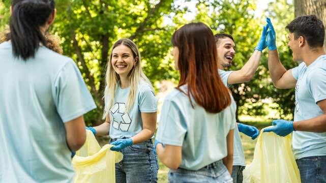 Group of volunteer cleaning picking up plastic litter in the park - Diverse group of people collect trash in the forest - Environmental protection, non profits organization and save the planet concept
