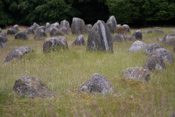 Ancient Viking burial site with stones on a grassy field