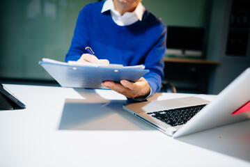 man Account Manager Working at Table with New Business Project. Typing keyboard,Using Contemporary...