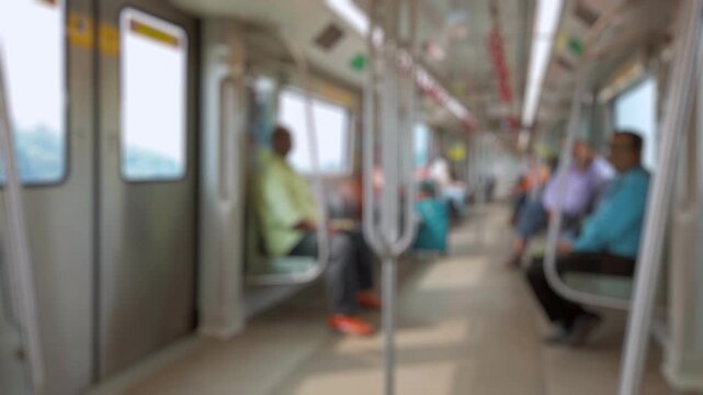 Bokeh view of passengers inside metro train in Lucknow, India. Blurred background footage.