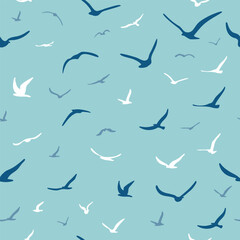 Obraz premium Flock of flying silhouette birds. Birds seamless pattern. White seagulls on a blue background. Vector