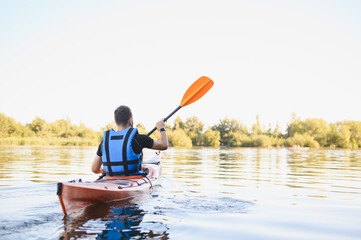 Kayaker paddling on calm lake enjoying water sports and active recreation