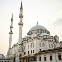 Fototapeta premium Majestic white mosque with towering minarets and a grand blue dome
