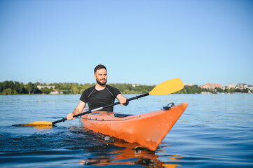Kayaker paddling on lake enjoying water sports in summer