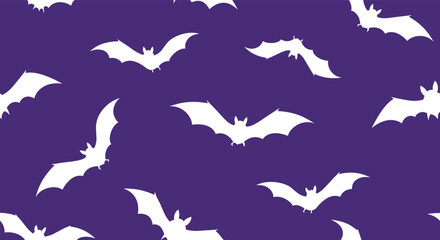 Spooky white bats flying on a dark purple background for halloween