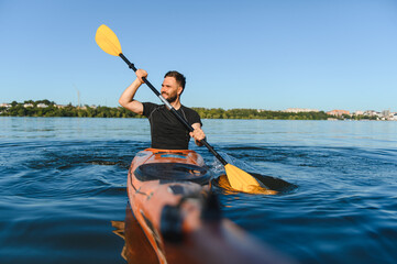 Kayaker paddling on river in sunny day, pov shot of kayaking