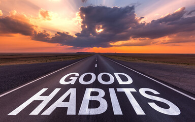 Open road with good habits message at sunset highway