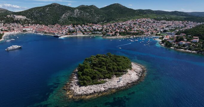 Scenic aerial shot of Hvar Town, Jerolim and Pakleni Islands with boats on the Adriatic Sea.