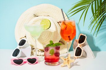 Summer alcohol Cocktail party. Margarita, Aperol Spritz and raspberry mojito at blue background.