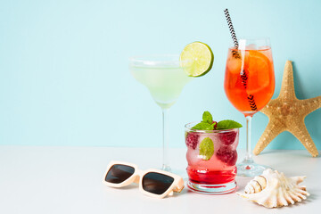 Summer alcohol Cocktail party. Margarita, Aperol Spritz and raspberry mojito with summer accessories.