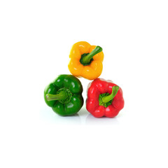 Three colorful bell peppers in yellow, green, and red placed together on white background — ideal...