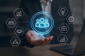 Businessman holding a digital hologram of a team with business icons around