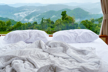 Cozy morning view from a bed overlooking lush green mountains - perfect for a peaceful retreat in nature and waking up to fresh mountain air.