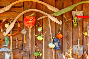 Various antique household items displayed on a wooden wall